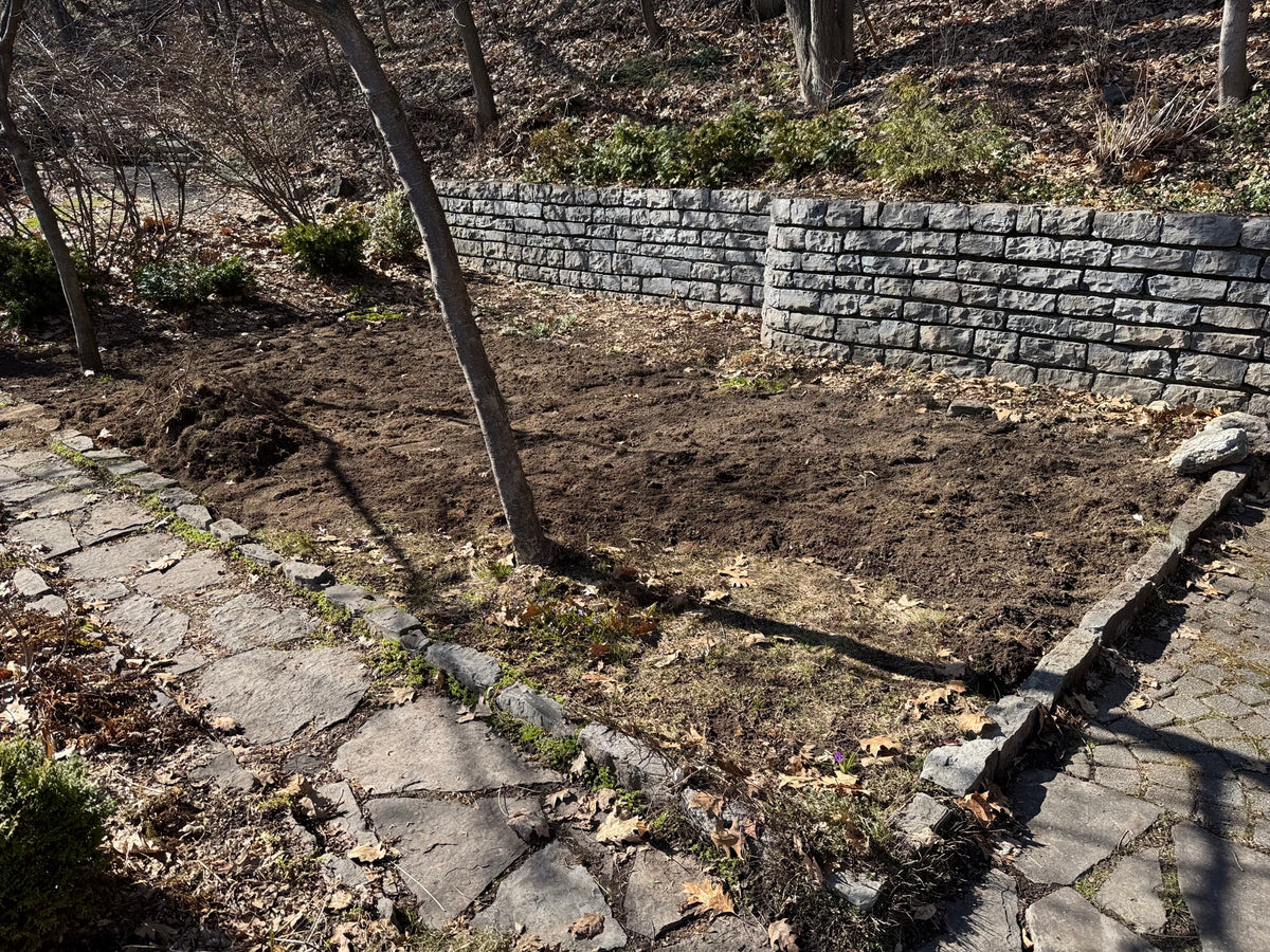 Site clean-up and prep in the retaining-wall garden bed